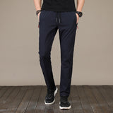 New Men's Casual Pants Autumn Winter Designer Solid Color Plus Size Slim Stretch Pants Men Loose Sweat Pants M~5XL AFK01